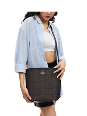 on-model-2-Coach-City-Large-Bucket-Bag-In-Signature-Canvas-Walnut-Black