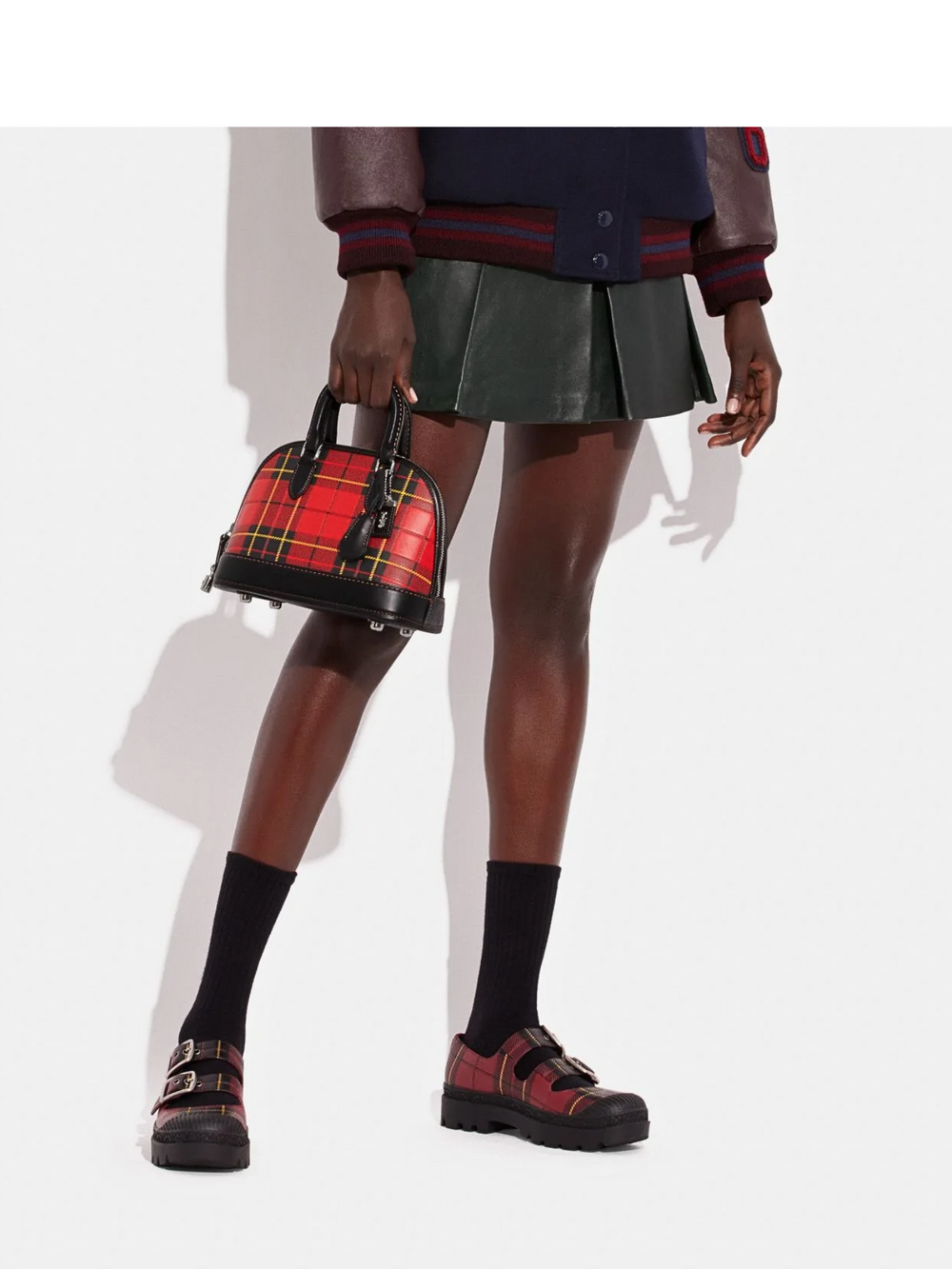 on-model-Coac-Revel-Bag-24-With-Plaid-Print-Sport-Red-Multi