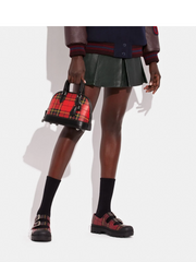 on-model-Coac-Revel-Bag-24-With-Plaid-Print-Sport-Red-Multi