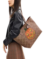 on-model-Coach-City-Tote-Bag-In-Signature-Canvas-With-Halloween-Print-Tan-Multi