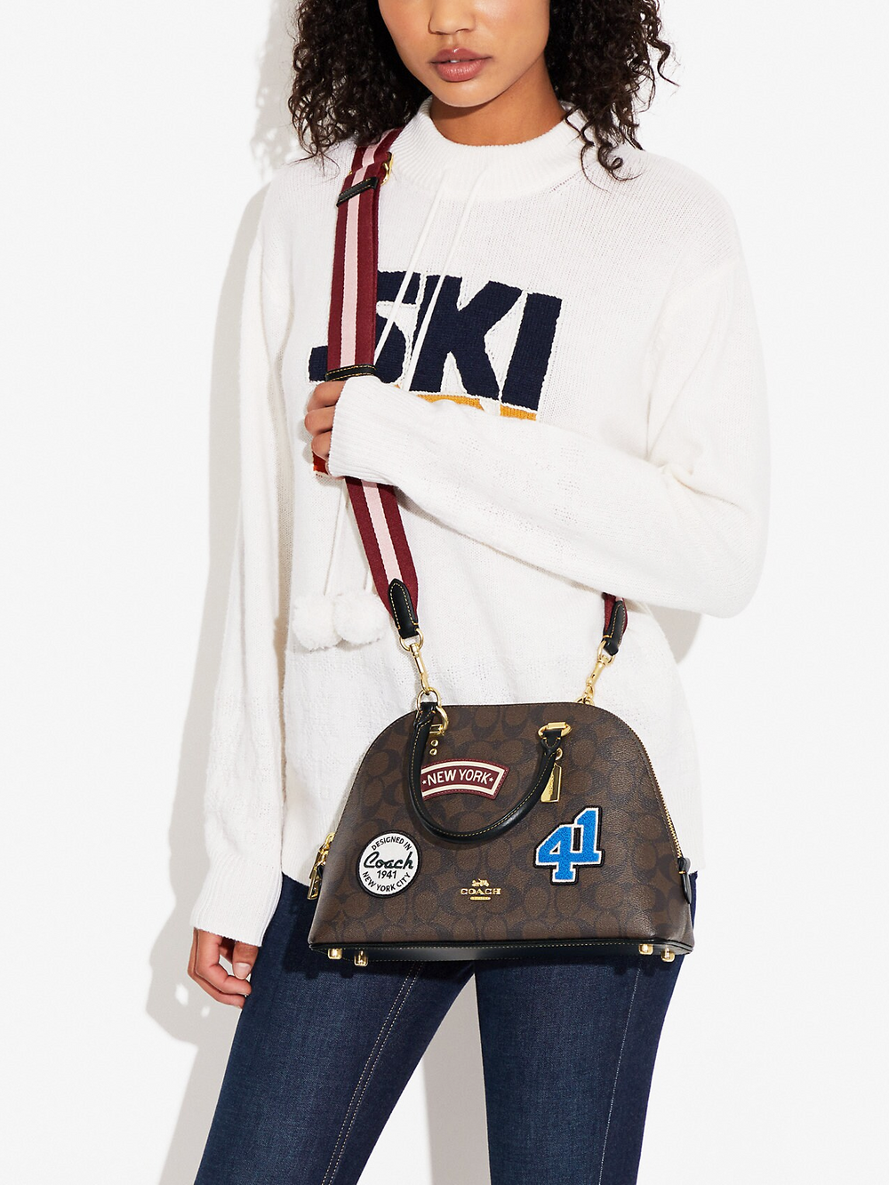 on-model-Coach-Katy-Satchel-In-Signature-Canvas-With-Ski-Patches-Brown-Black-Multi