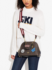 on-model-Coach-Katy-Satchel-In-Signature-Canvas-With-Ski-Patches-Brown-Black-Multi
