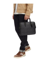 on-model-Coach-Liam-Compact-Brief-In-Signature-Canvas-Charcoal-Black