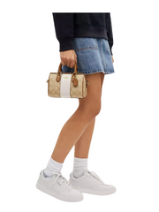 on-model-Coach-Mini-Rowan-Crossbody-In-Signature-Canvas-With-Stripe-Light-Khaki-Chalk-Saddle