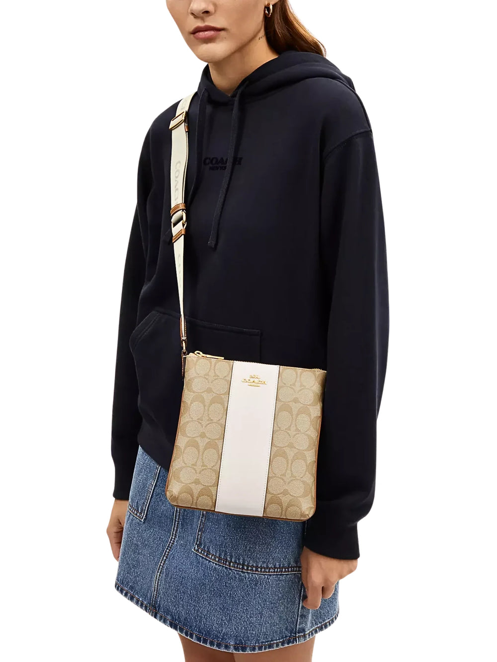 on-model-Coach-Mini-Rowan-File-Bag-In-Signature-Canvas-With-Stripe-Light-Khaki-Chalk-Saddle