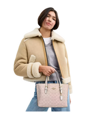on-model-Coach-Mollie-Tote-Bag-25-In_-Signature-Canvas-Sand-Chalk