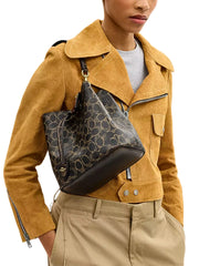 on-model-Coach-Rowan-Bucket-Bag-In-Loved-Signature-Canvas-With-Charms-Brown