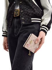 on-model-Coach-Snap-Wallet-In-Signature-Canvas-With-Floral-Print-Sand-Multi
