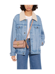 on-model-Coach-Studio-Baguette-Mini-In-Patent-Leather-Shoulder-Bag-Latte