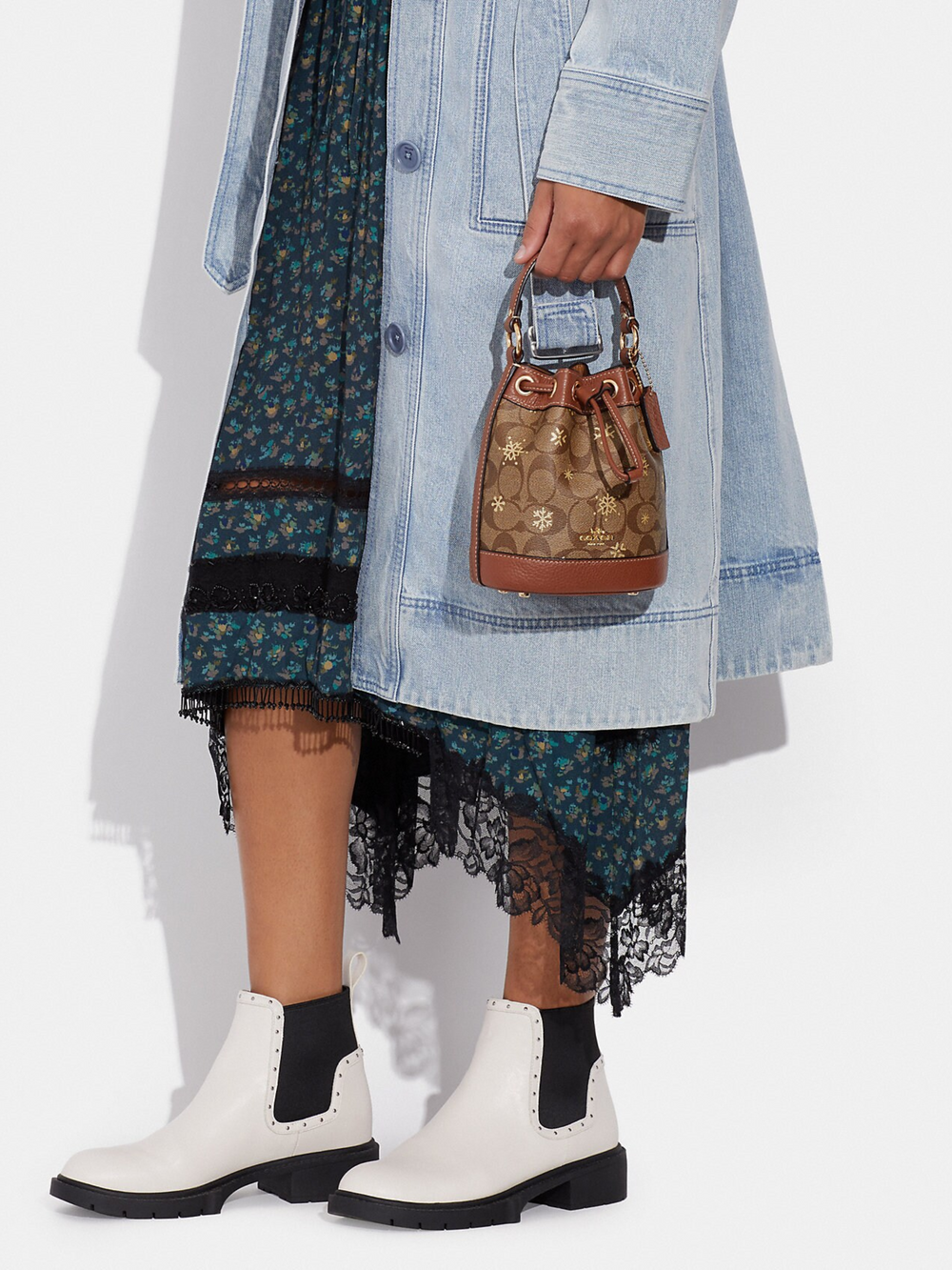 on-model2-Coach- Dempsey-Drawstring- Bucket -Bag -15 -In- Signature -Canvas -With- Snowflake Print -Khaki -Multi