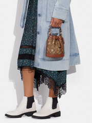 on-model2-Coach- Dempsey-Drawstring- Bucket -Bag -15 -In- Signature -Canvas -With- Snowflake Print -Khaki -Multi