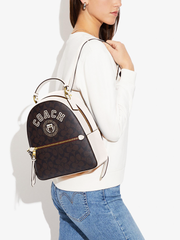 Coach-Jordyn-Backpack-In-Signature-Canvas-With-Varsity-Motif-Brown-Buttercup-Balilene-onmodel
