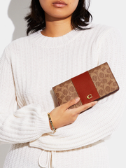 Coach-Slim-Wallet-In-Signature-Canvas-Tan-Rust-Balilene-onmodel
