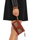 on-model-1-Coach-Tabby-Wristlet-In-Signature-Canvas-Tan-Rust