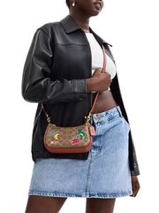 on-model-1-shoulder-Coach-Teri-Mini-Crossbody-Bag-In-Signature-Canvas-With-Sticker-Print-Tan-Multi