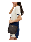on-model-2-Coach-City-Bucket-Bag-In-Signature-Canvas-Walnut-Black