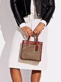 on-model-2-Coach-Field-Tote-22-In-Signature-Canvas-With-Horse-And-Carriage-Print-Tan-Multi