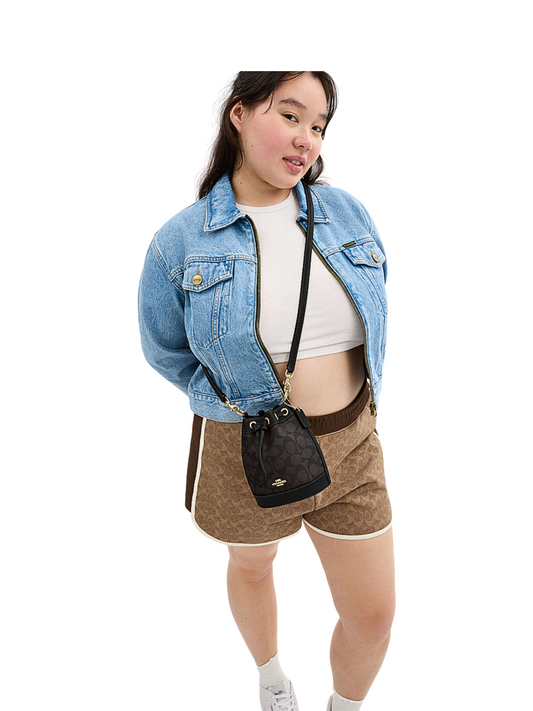 on-model-2-Coach-Mini-Bucket-Bag-In-Signature-Canvas-Walnut-Black