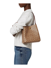 on-model-Coach-Charlie-Bucket-Bag-22-In-Signature-Canvas-Tan-Rust