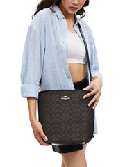 on-model-Coach-City-Large-Bucket-Bag-In-Signature-Canvas-Walnut-Black