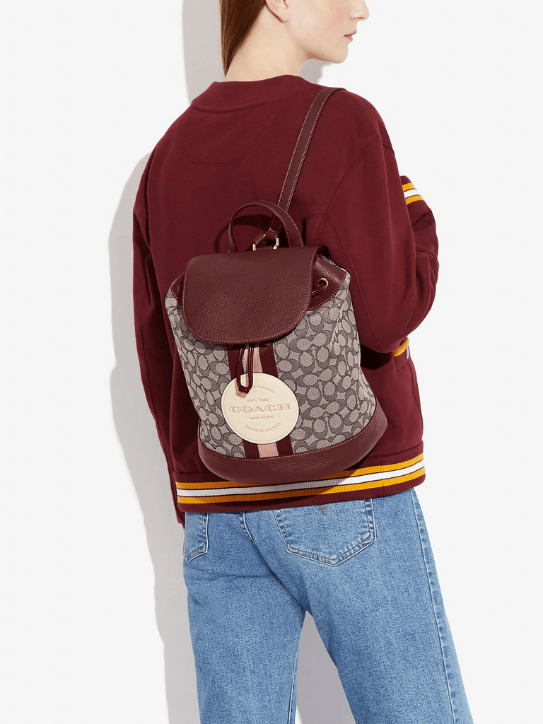 on-model-Coach-Dempsey-Drawstring-Backpack-In-Signature-Jacquard-With-Stripe-And-Coach-Patch-Wine-Multi
