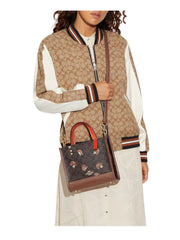 on-model-Coach-Dempsey-Tote-22-In-Signature-Canvas-With-Hedgehog-Print-Brown-Black-MultiWEBP