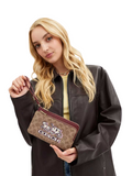 on-model-Coach-Double-Zip-Wallet-In-Signature-Canvas-With-Horse-And-Carriage-Print-Tan-Black-Cherry