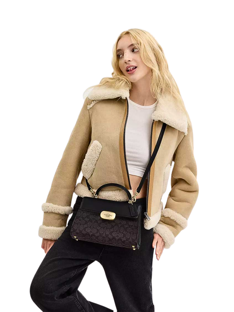 on-model-Coach-Eliza-Top-Handle-Bag-In-Signature-Canvas-Walnut-Black