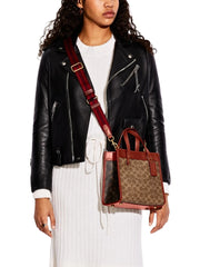 on-model-Coach-Field-Tote-22-In-Signature-Canvas-With-Horse-And-Carriage-Print-Tan-Truffle