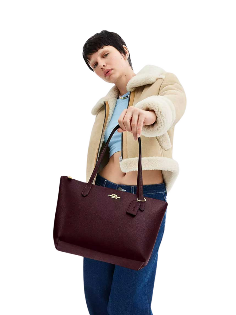 on-model-Coach-Fiona-Zip-Tote-Bag-Black-Merlot