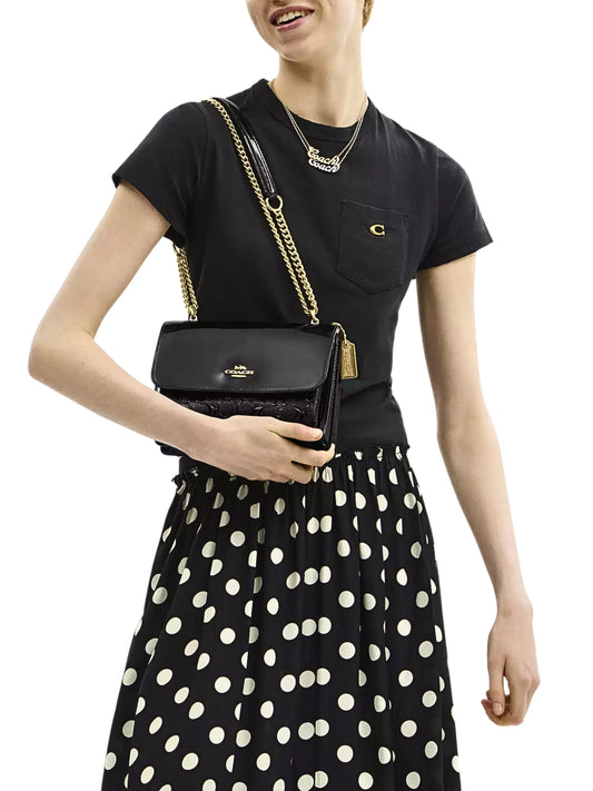 on-model-Coach-Klare-Crossbody-Bag-In-Signature-Patent-Leather-Black