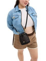 on-model-Coach-Mini-Bucket-Bag-In-Signature-Canvas-Walnut-Black