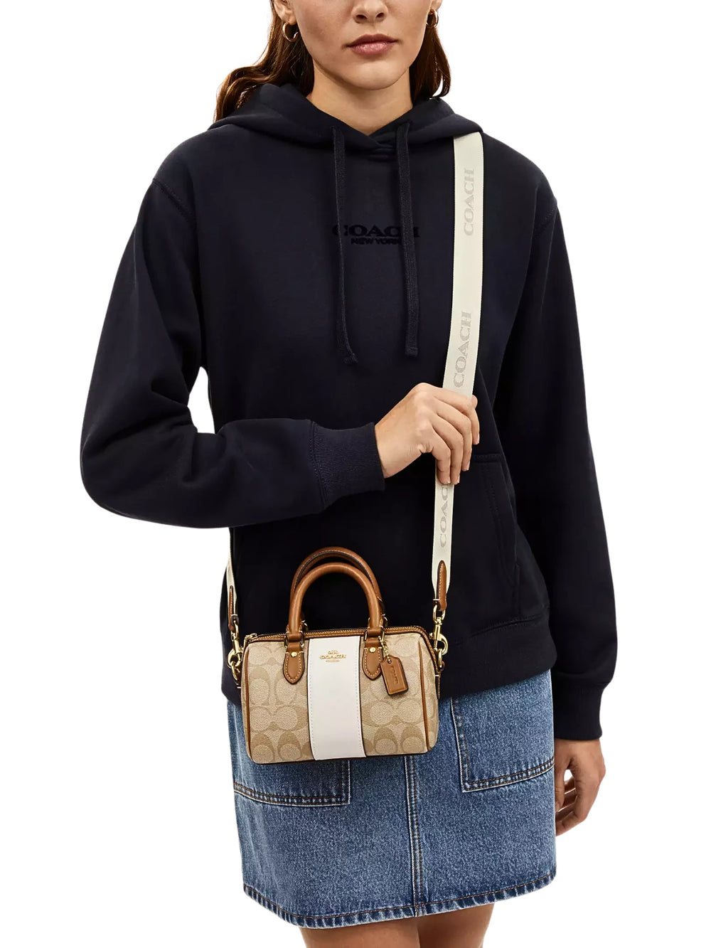on-model-Coach-Mini-Rowan-Crossbody-In-Signature-Canvas-With-Stripe-Light-Khaki-Chalk-Saddle