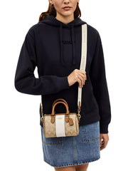 on-model-Coach-Mini-Rowan-Crossbody-In-Signature-Canvas-With-Stripe-Light-Khaki-Chalk-Saddle