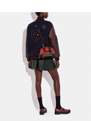 on-model-Coach-Revel-Bag-24-With-Plaid-Print-Sport-Red-Multi