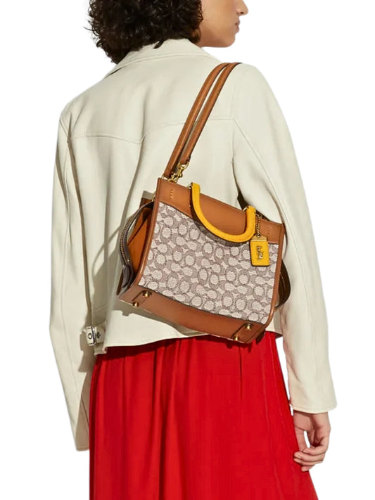 on-model-Coach-Rogue-25-In-Signature-Textile-Jacquard-Cocoa-Burnished-Amber-balilene