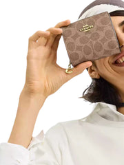 on-model-Coach-Snap-Wallet-In-Signature-Canvas-Tan-Brown
