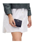 on-model-Coach-Snap-Wallet-In-Signature-PVC-DenimMidnight-Navy