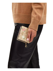 on-model-Coach-Snap-Wallet-In-Signature-With-Floral-Print-Light-Khaki-Chalk-Multi