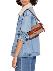 on-model-Coach-Studio-Baguette-Bag-In-Signature-Canvas-Tan-Rust