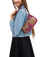 on-model-Coach-Teri-Shoulder-Bag-In-Signature-Canvas-With-Bow-Print-Tan-Pink-Multi