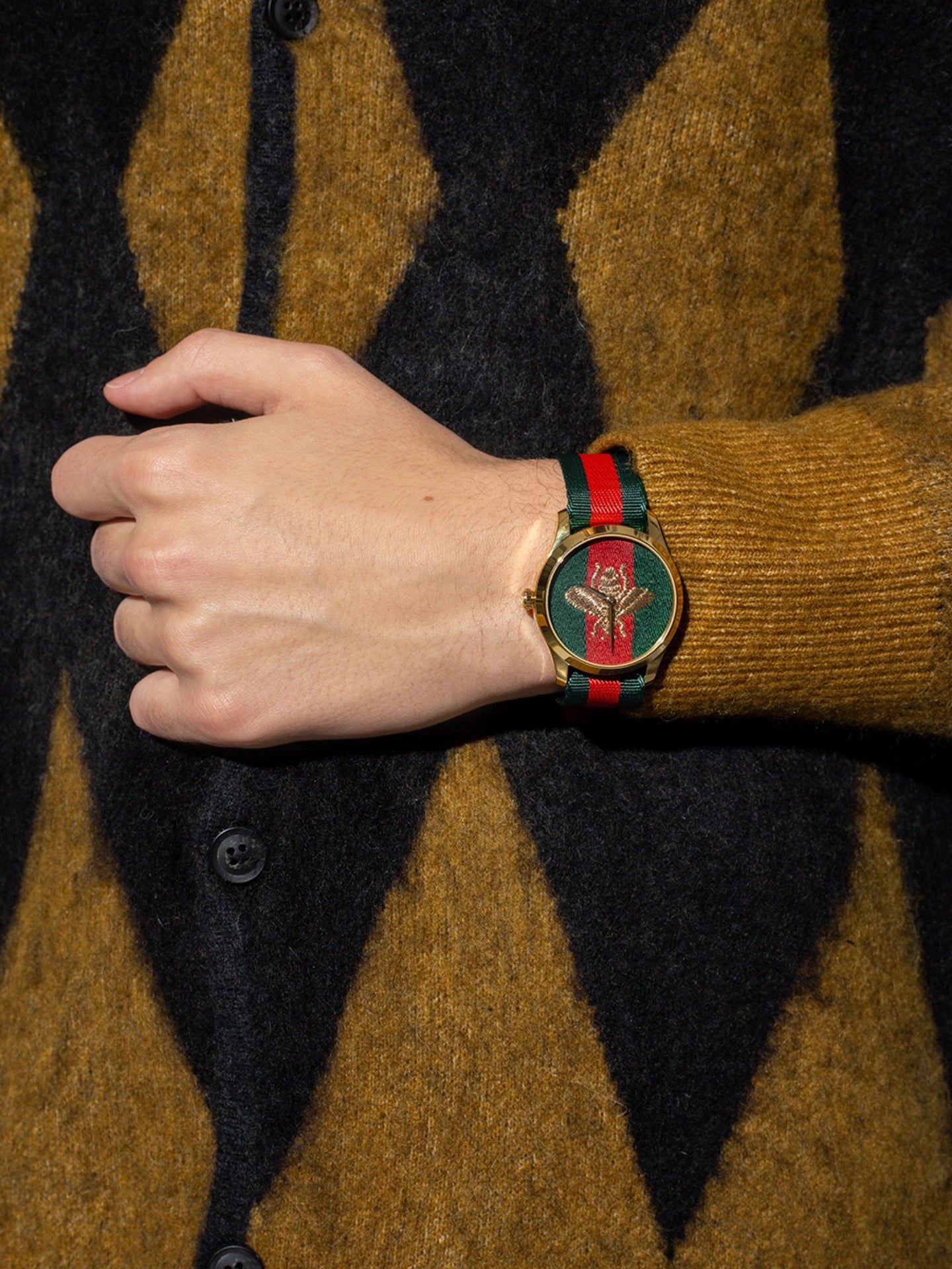 on-model-Gucci-G-Timeless-Bee-Red-_-Green-Dial-Two-Tone-Nylon-Strap-Watch
