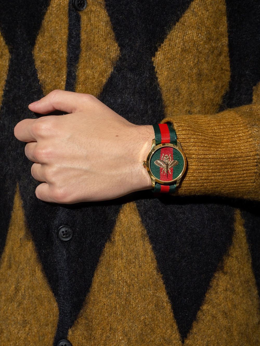 on-model-Gucci-G-Timeless-Bee-Red-_-Green-Dial-Two-Tone-Nylon-Strap-Watch