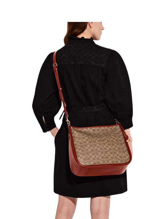 on-model-selempang-Coach-Cary-Shoulder-Bag-In-Signature-Canvas-Tan-Rust