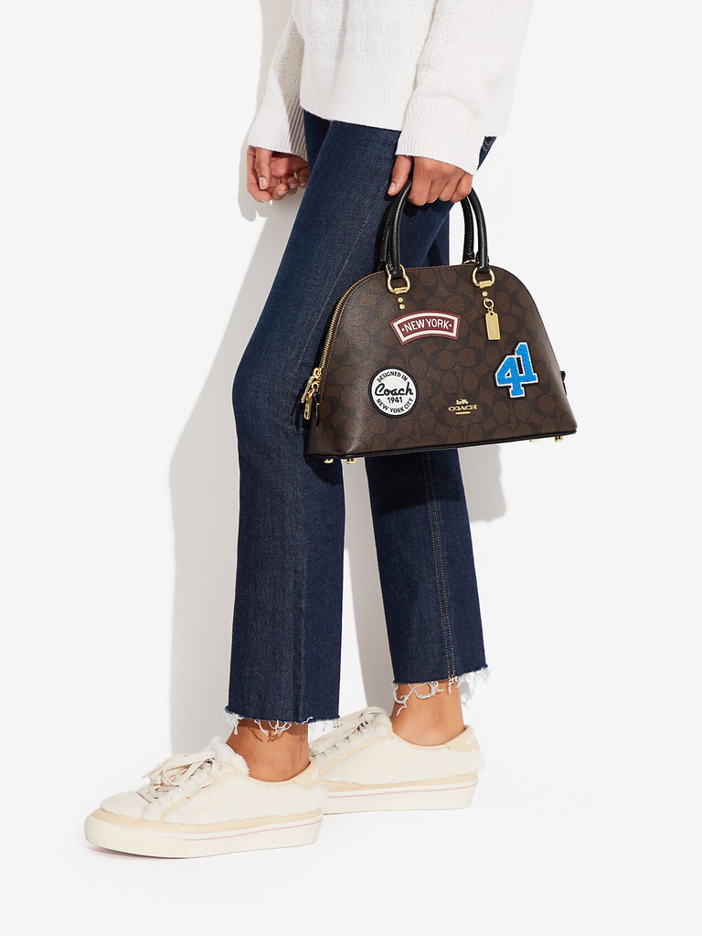 on-model1-Coach-Katy-Satchel-In-Signature-Canvas-With-Ski-Patches-Brown-Black-Multi