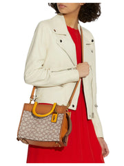 on-model1-Coach-Rogue-25-In-Signature-Textile-Jacquard-Cocoa-Burnished-Amber