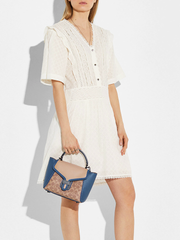 Coach-Courier-Carryall-23-In-Colorblock-Signature-Canvas-Pewter-Tan-Dark-Denim-Multi-Balilene-onmodel